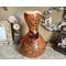 This is a handmade gourd vase with hummingbird artwork. The rim is carved with a wavy edge. The vase decorates and entryway table. 